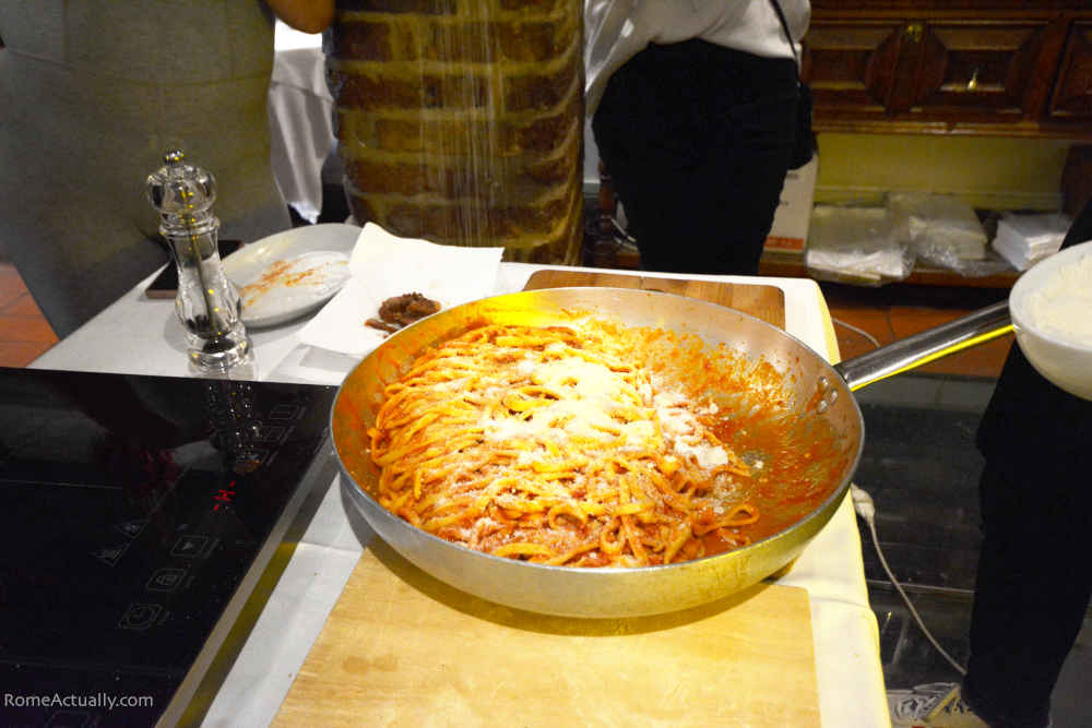 Image: Adding the cheese on our pasta in Rome Pasta-Making Class in Trastevere with Devour Tours